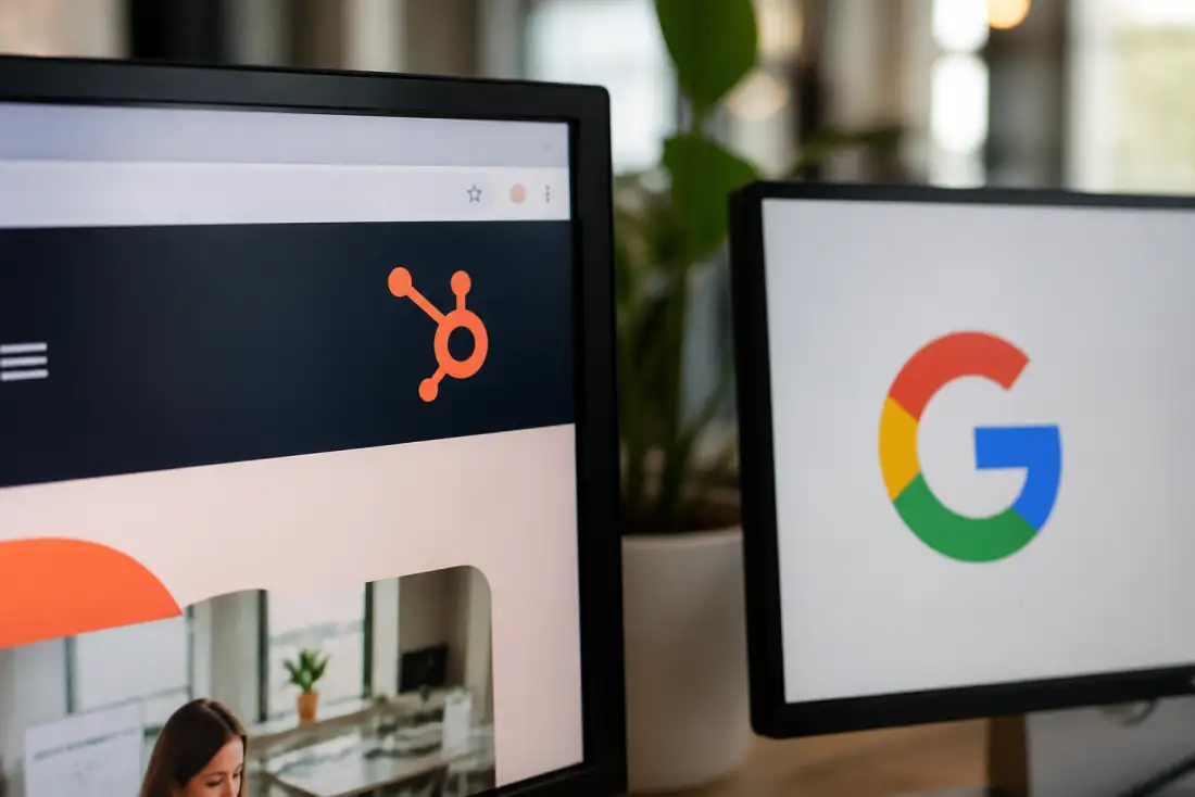 Monitor showing the HubSpot logo in a marketing workspace